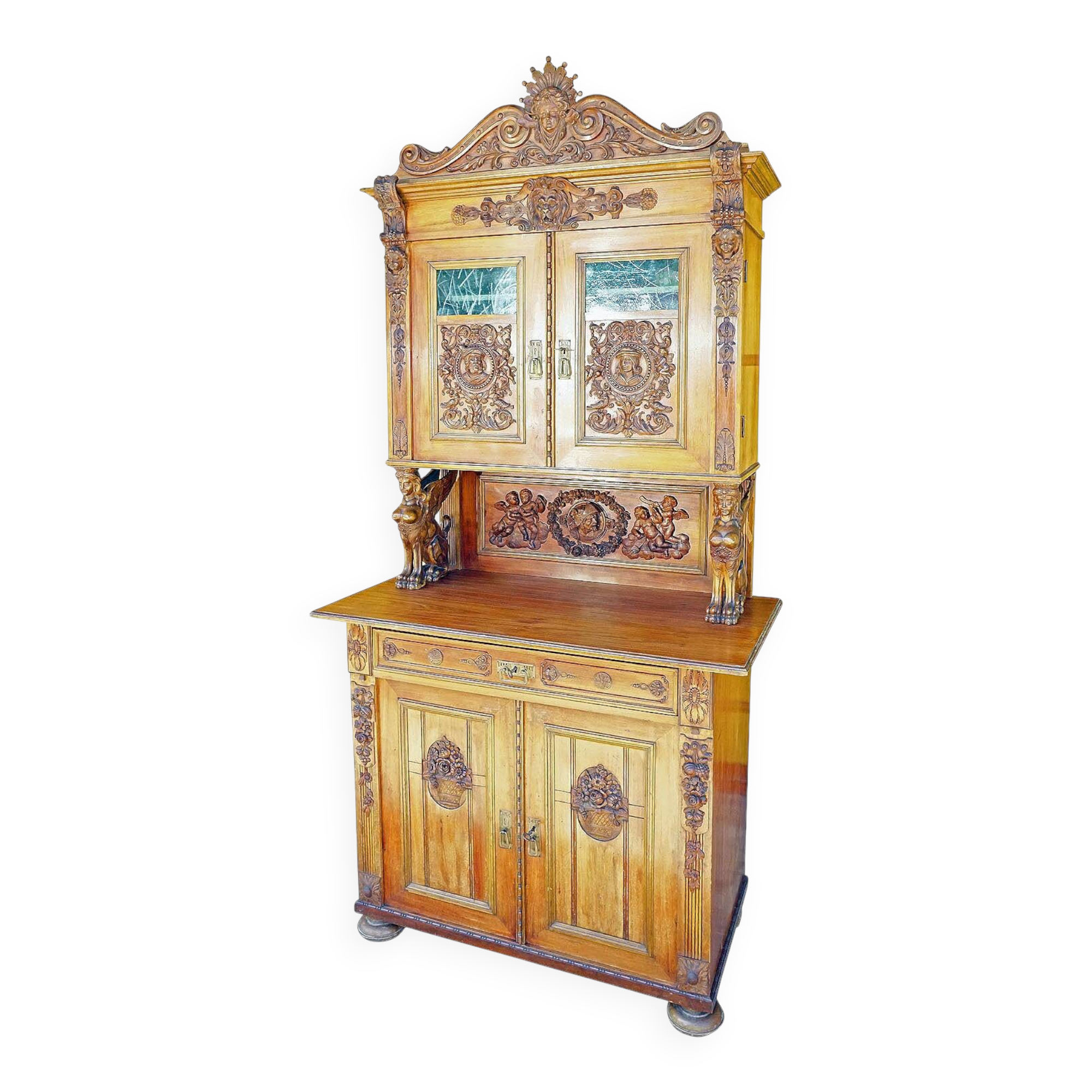 Antique carved wooden sideboard with several sculptures.