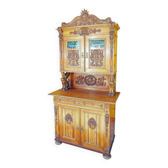 Antique carved wooden sideboard with several sculptures.