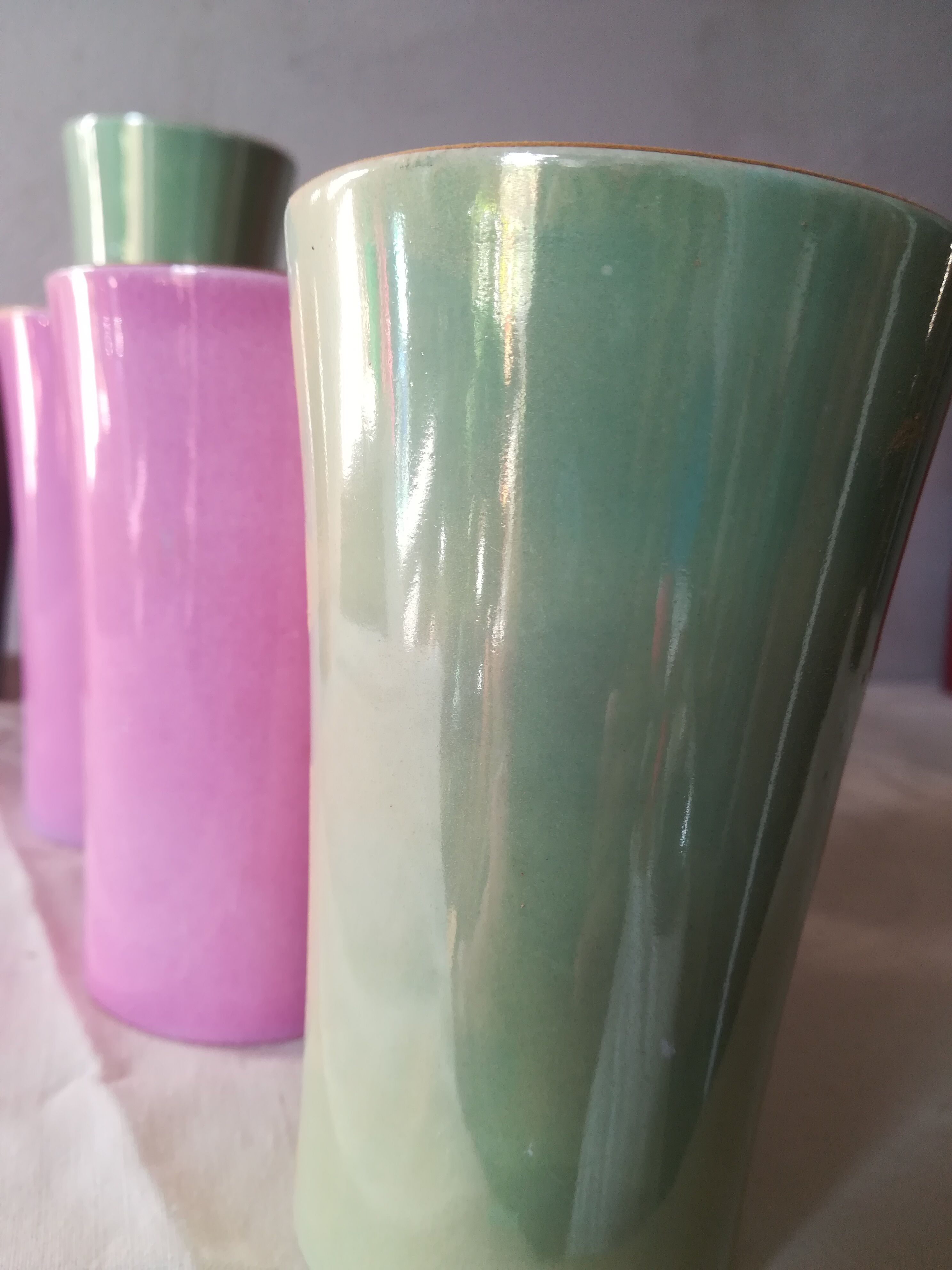 8 coloured cups in earthenware