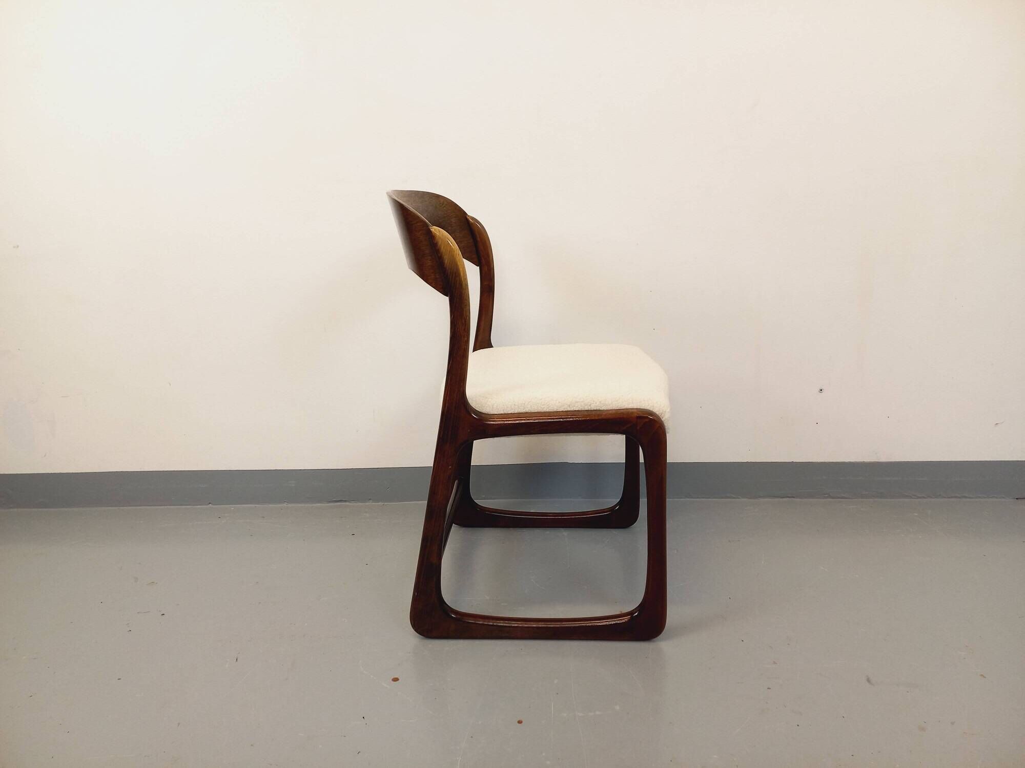Vintage sled chair by Baumann in wood and boucle fabric.