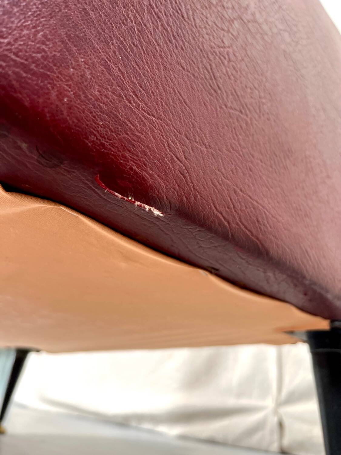 Vintage burgundy armchair, compass base in black metal and brass