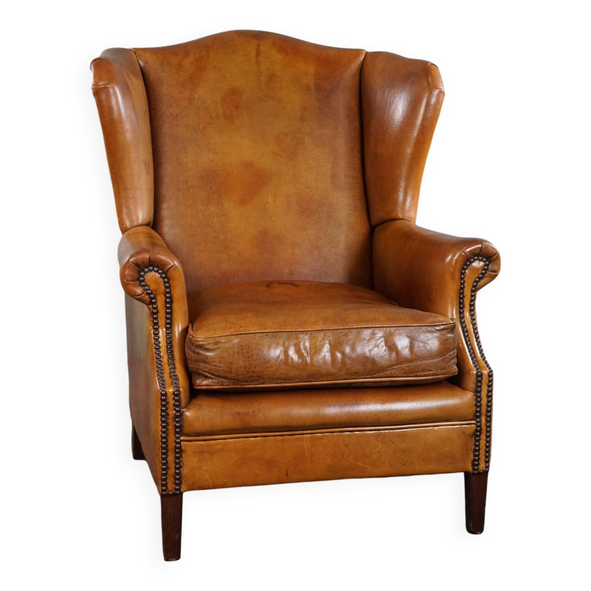 Wingback chair made of sheepskin leather in a light honey color