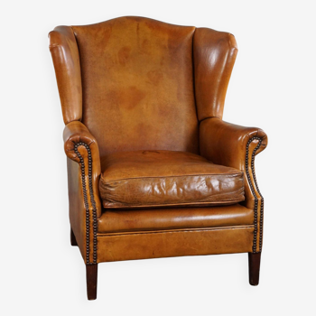 Wingback chair made of sheepskin leather in a light honey color
