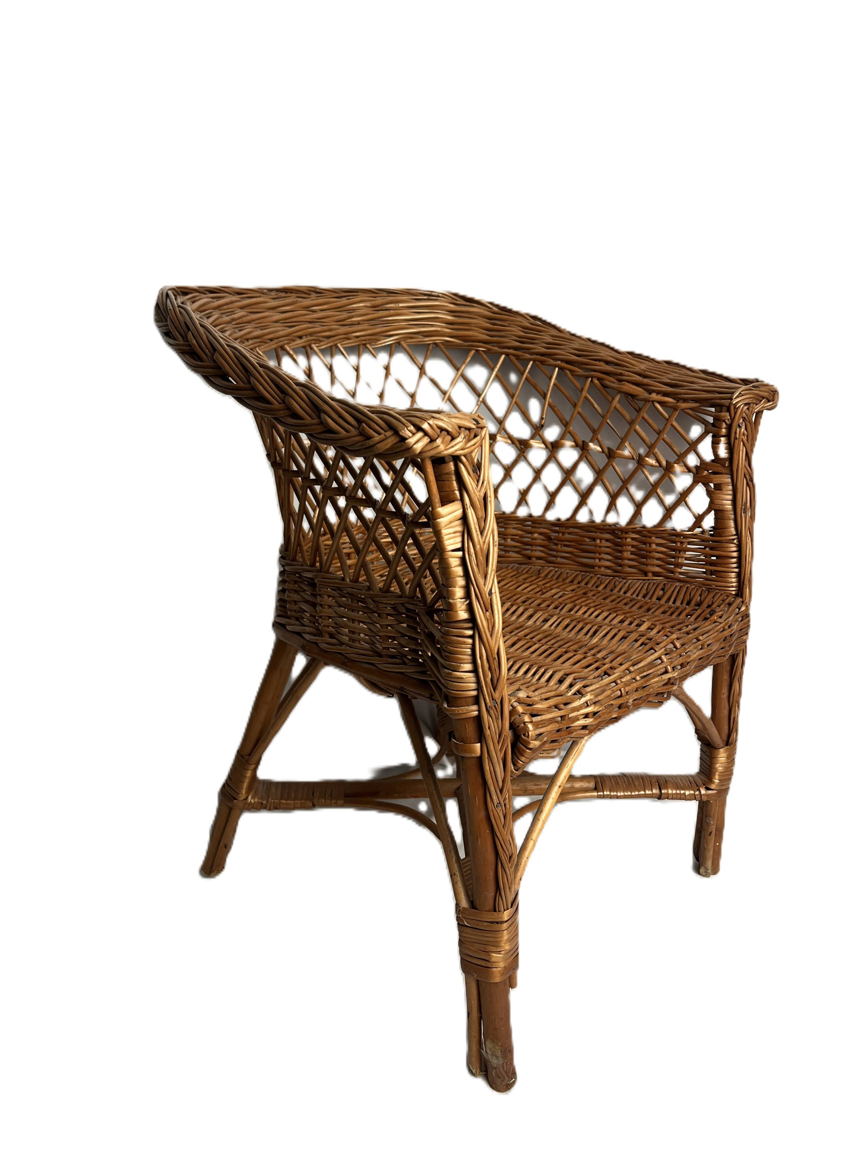 Vintage, children's armchair in woven rattan from around 1970.