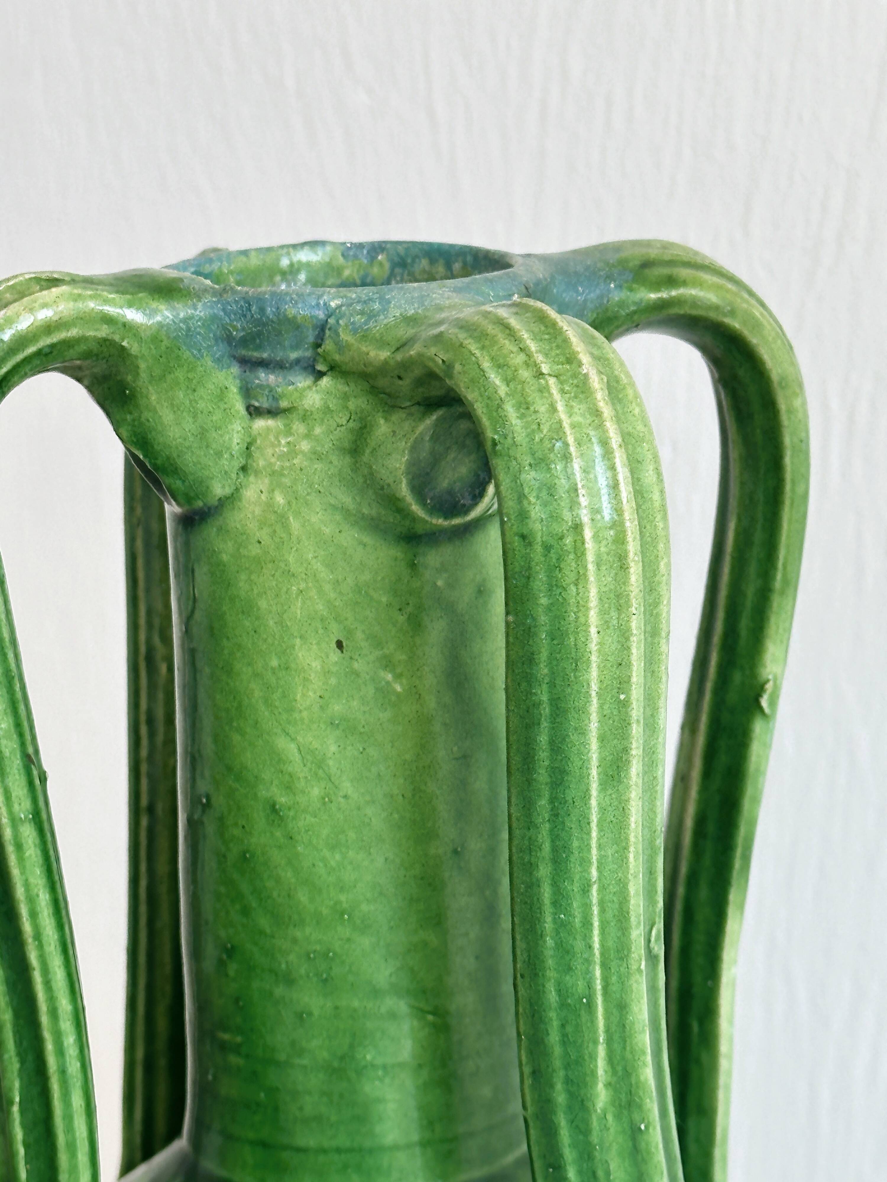 Pottery green ceramic vase with four handles.