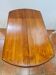 Table ronde 4 pieds en merisier avec 2 allonges