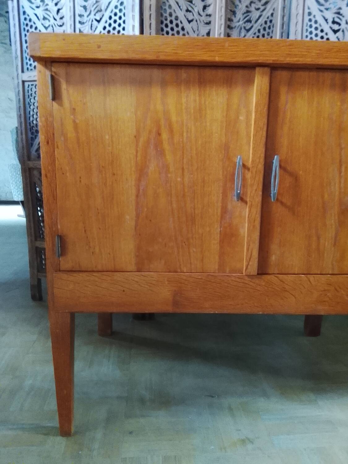 Vintage storage unit with two doors and four drawers.
