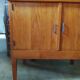 Vintage storage unit with two doors and four drawers.