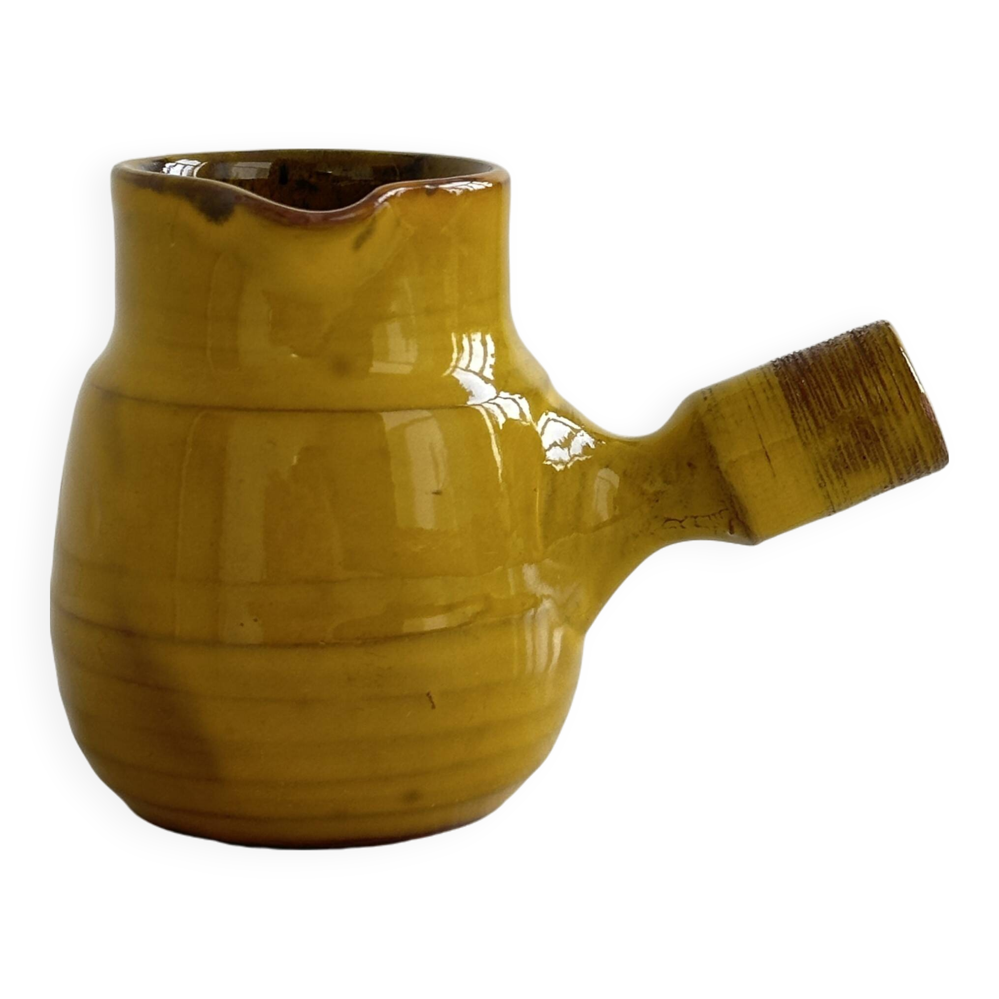 Yellow glazed ceramic sauce boat or milk jug
