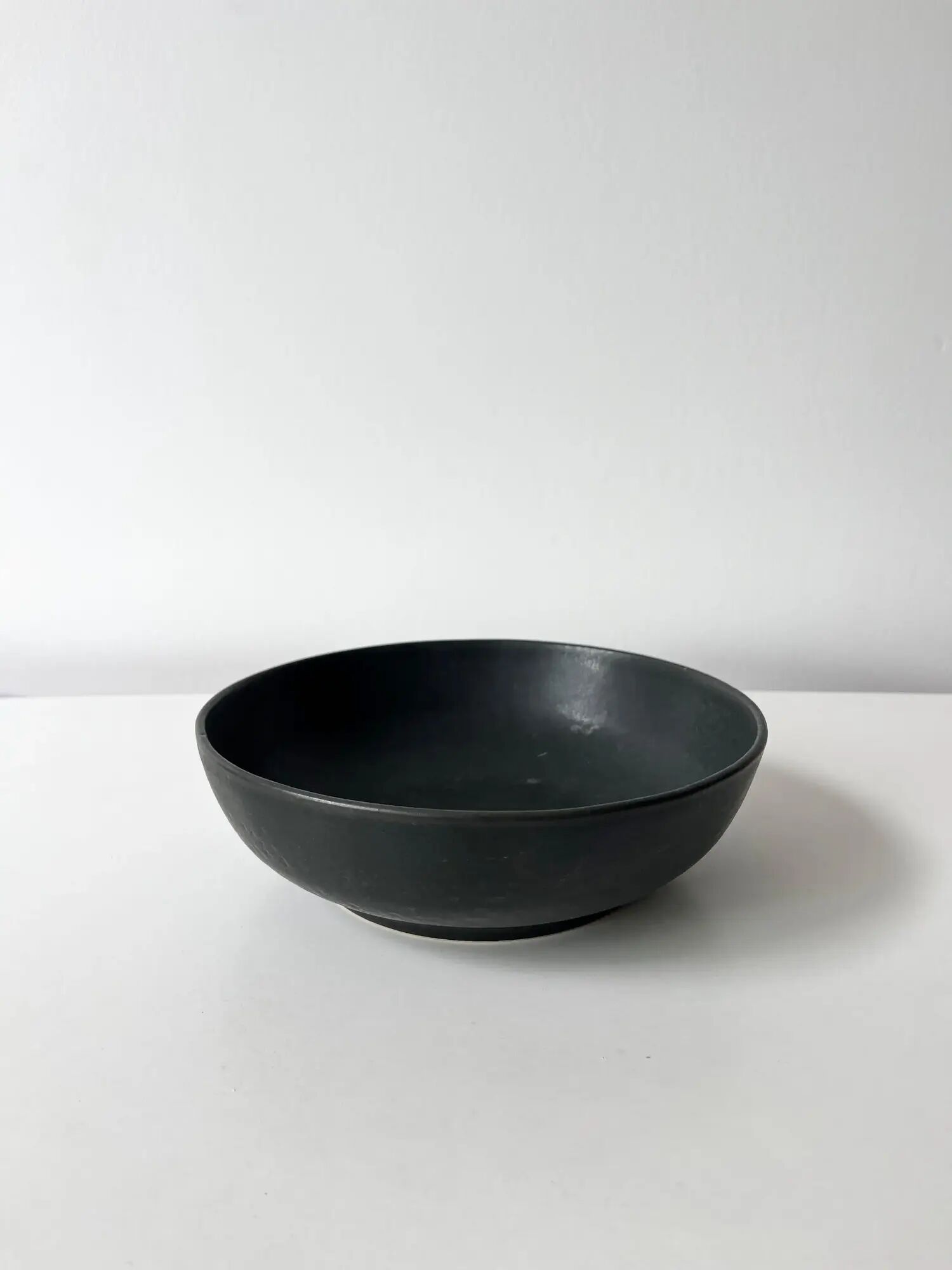 Round vintage black ceramic catchall.