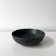 Round vintage black ceramic catchall.