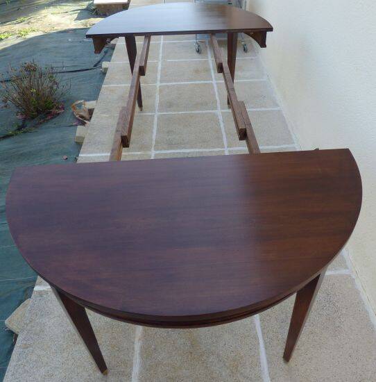 Round mahogany table with mahogany veneer and brass sabot foot.