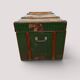 Vintage wooden and metal green travel trunk, circa 1930.