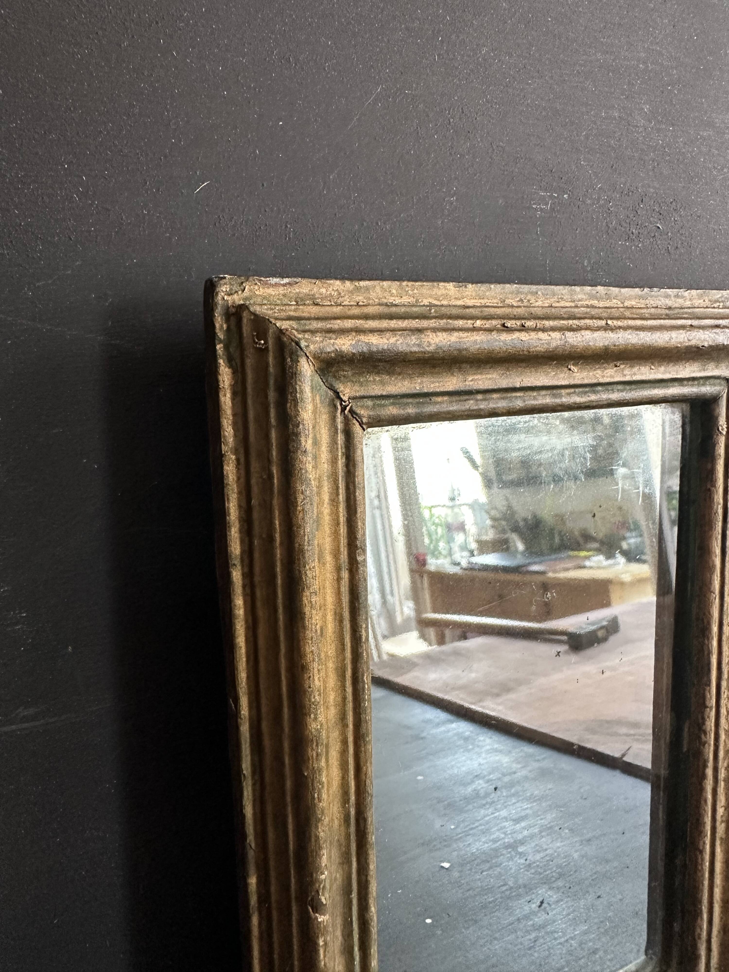 Miniature mirror from the 18th century in gilded wood, mercury glass.