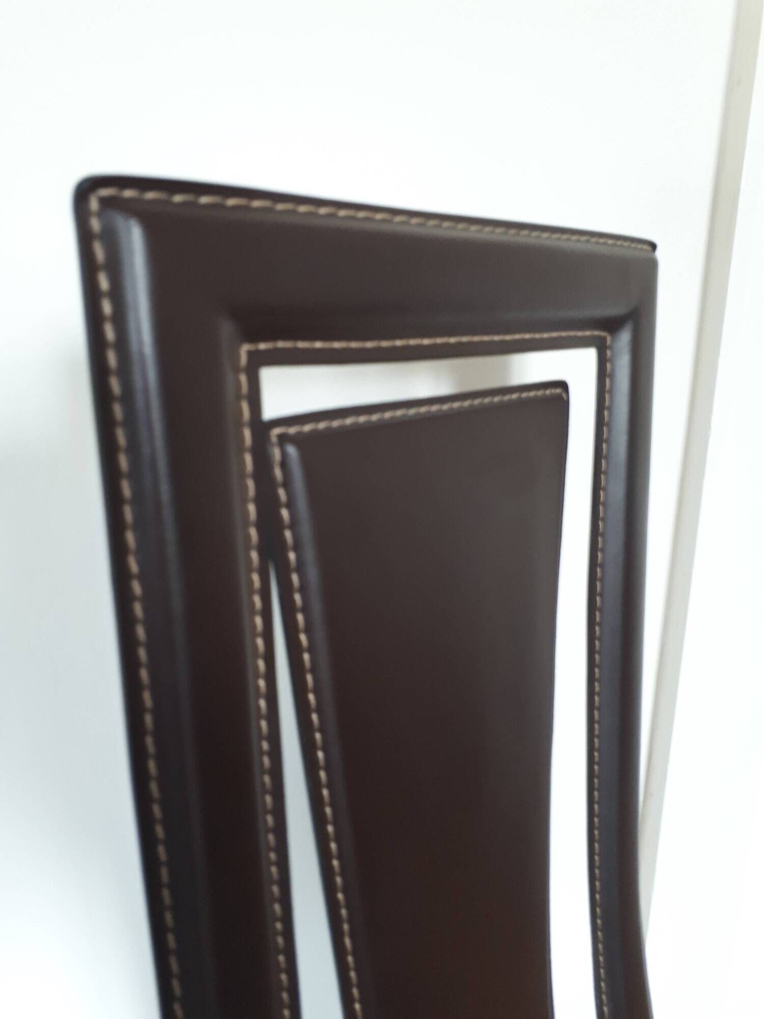 Set of 6 wooden chairs covered in leather.