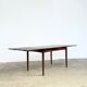 Rosewood dining table with integrated extensions — Denmark, 1960s