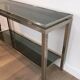 Beautiful console table in brushed metal with bluish glass shelves