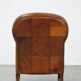 Unique, luxurious sheepskin armchair combined with wood and finished with decorative nails