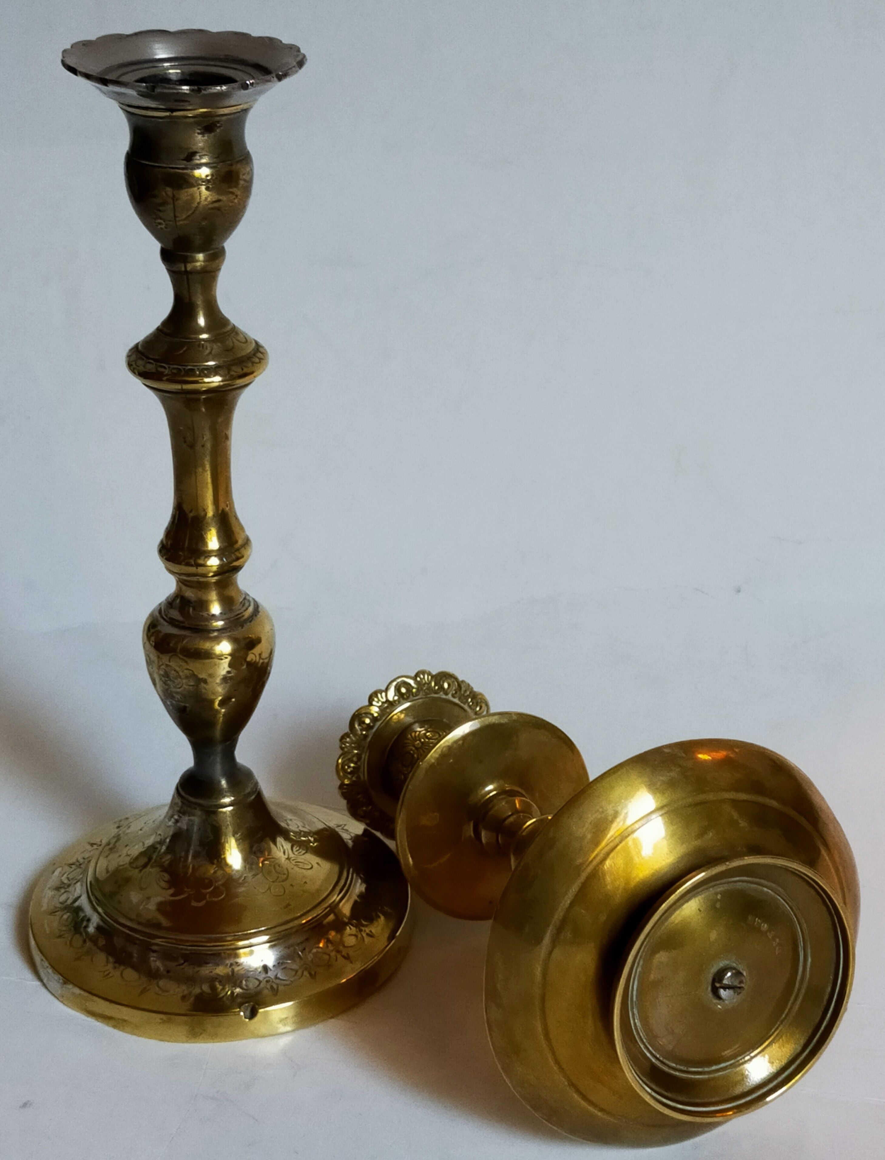 Duo of solid brass and gold metal candle holders worked old