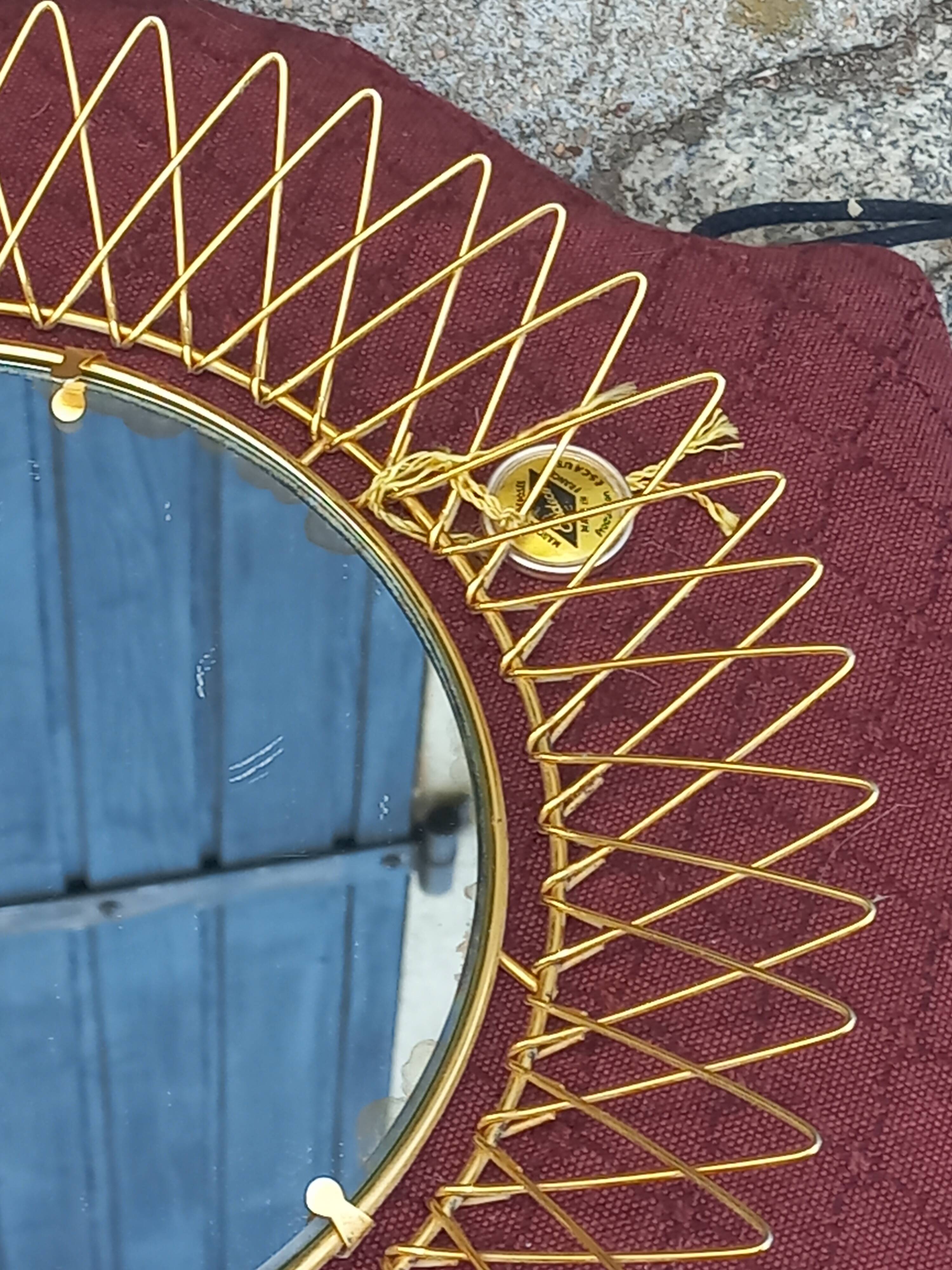 Vintage 1950s sun mirror in gold metal.