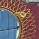 Vintage 1950s sun mirror in gold metal.