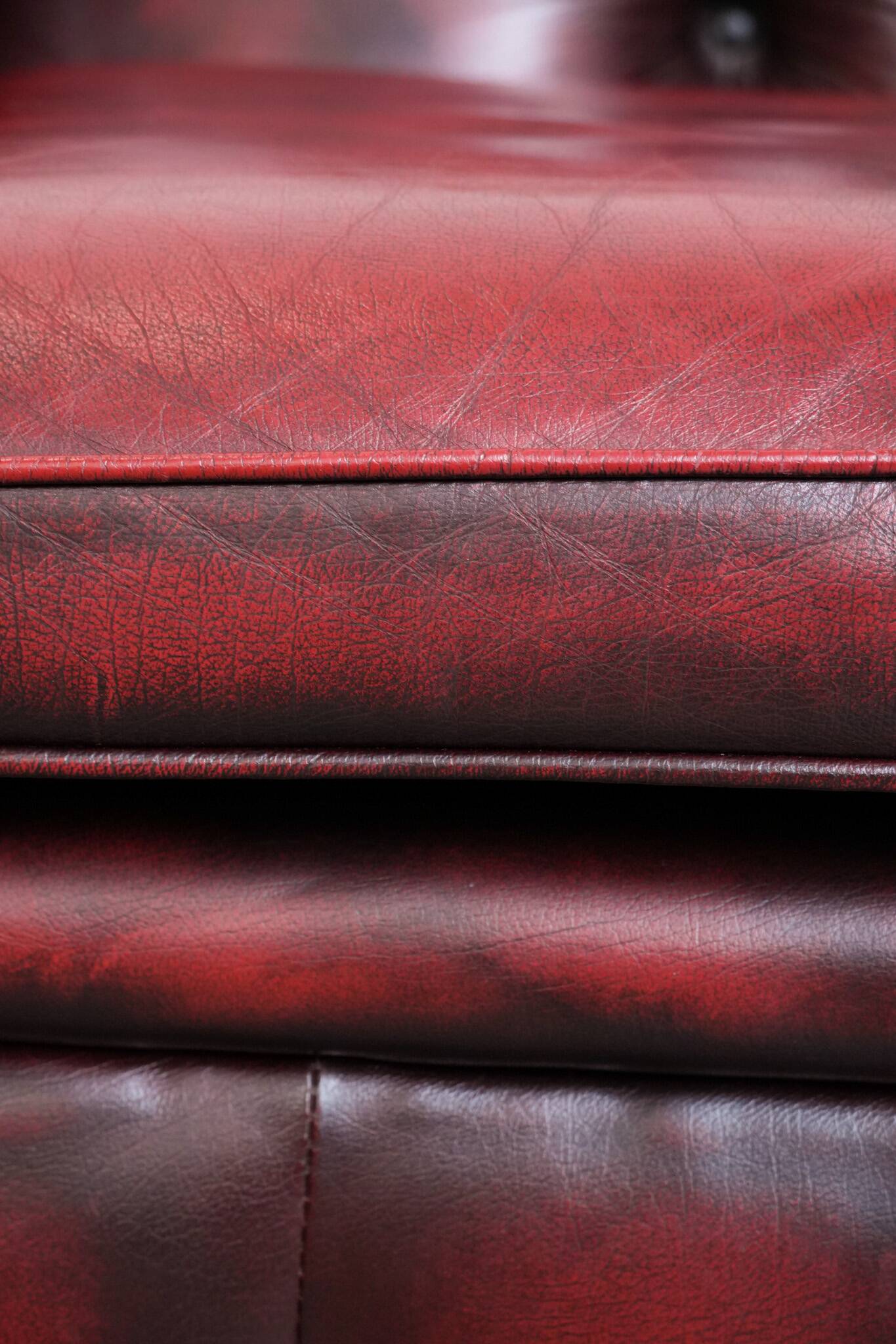 Red English cowhide Chesterfield armchair finished with decorative nails