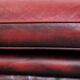 Red English cowhide Chesterfield armchair finished with decorative nails
