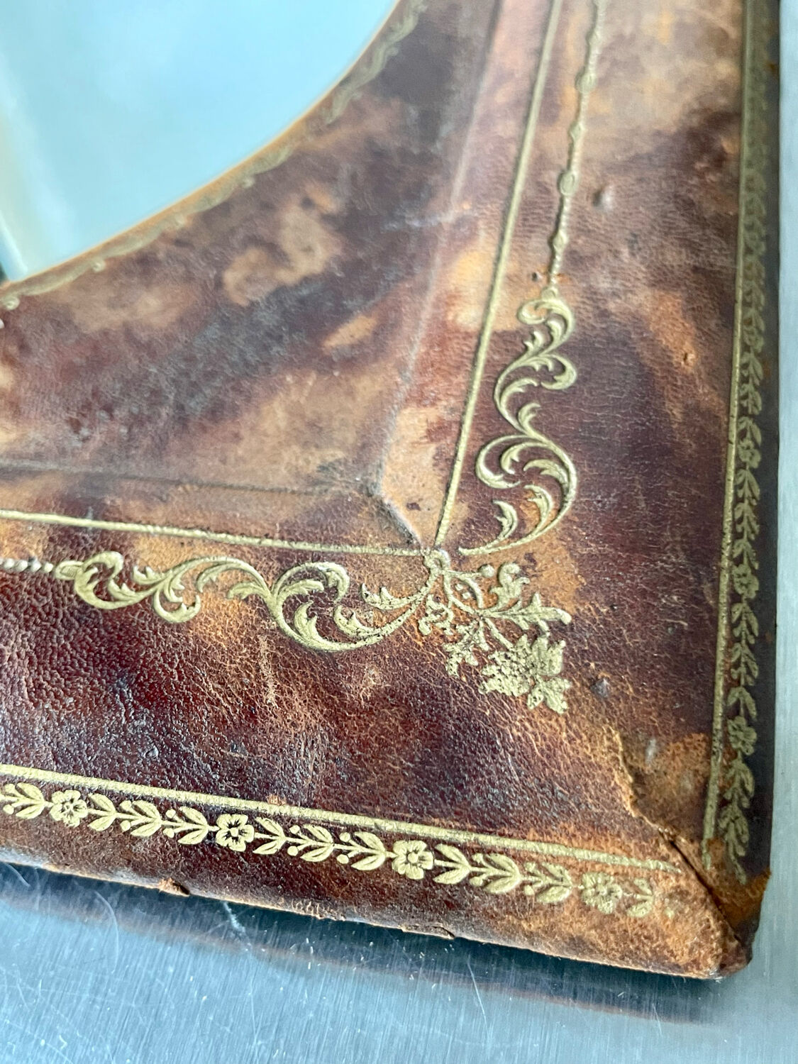 Antique leather framed mirror with gildings 30 cm x  24 cm