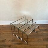 Modernist work, suite of three trundle tables in chromed metal and glass