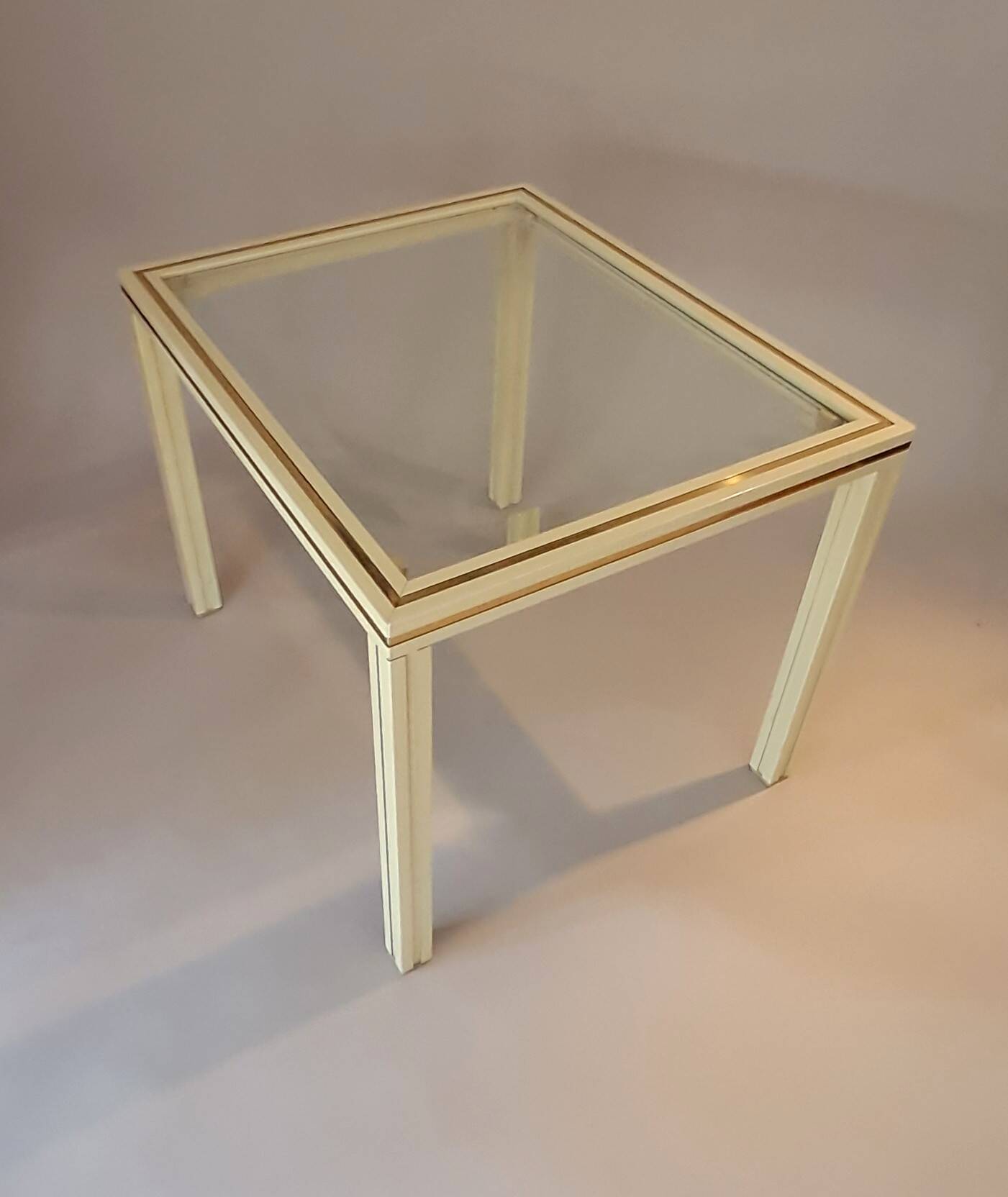 White lacquered side table by Pierre Vandel with gold brass.