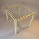 White lacquered side table by Pierre Vandel with gold brass.