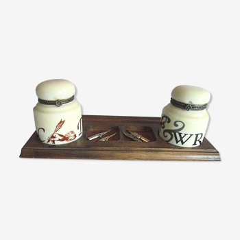 Antique ceramic inkwells on wood support with 4 feathers