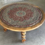 Vintage wooden turned coffee table with leather and astrological decoration.