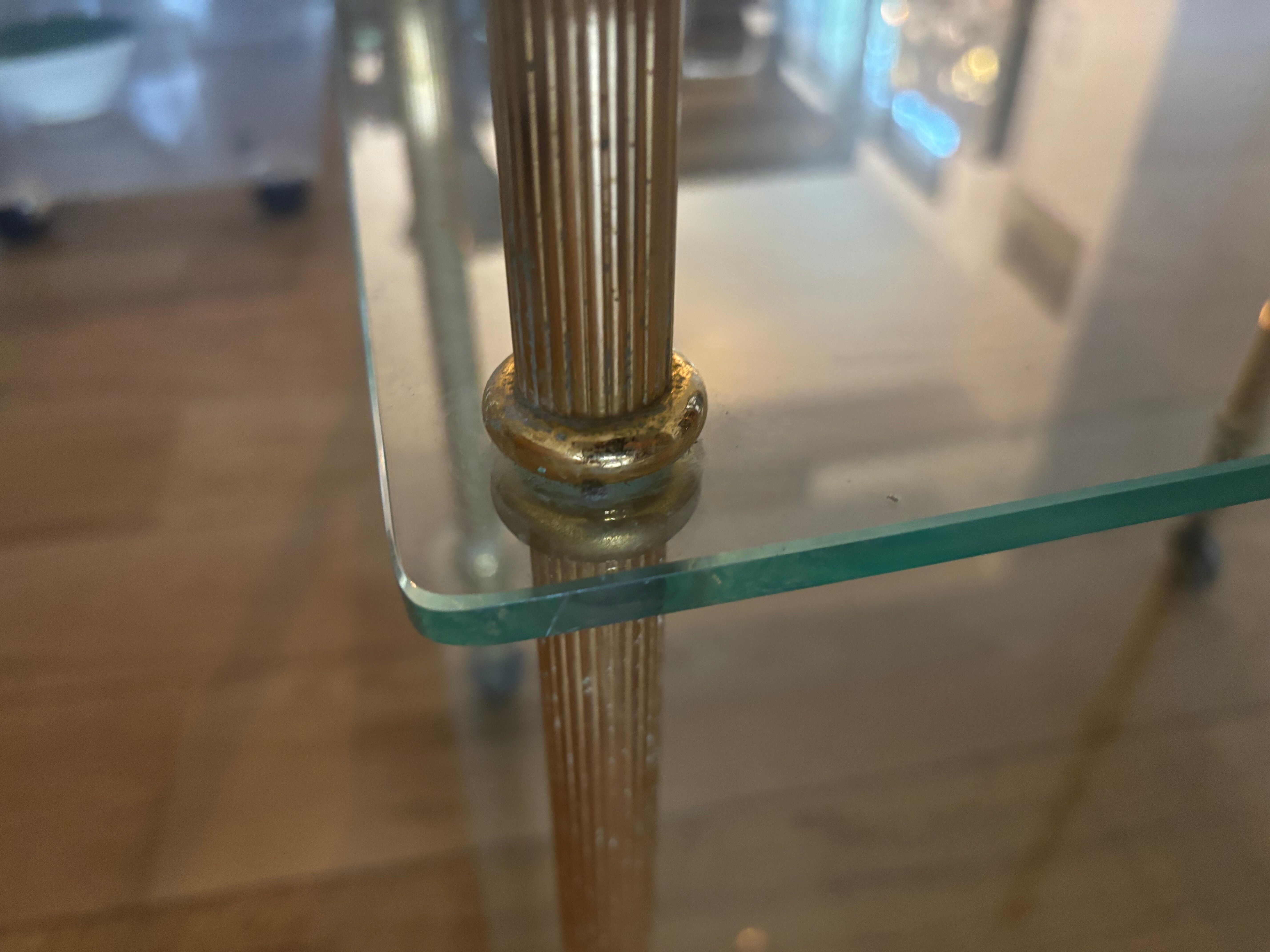 Elegant wheeled serving trolley in gilded brass and glass, in a spirit