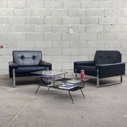 Pair of black leather armchairs