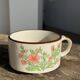 Small speckled stoneware cup made in Korea with a floral pattern H7 D11