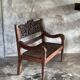 Small antique Indonesian bench in carved teak with plant and floral motifs.