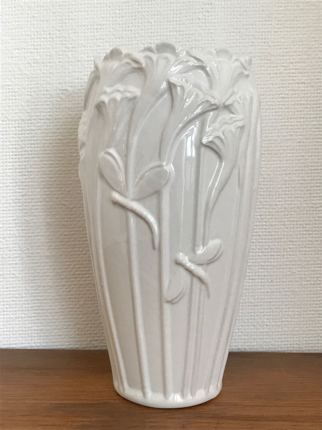 Old white art nouveau vase with flowers and dragonflies