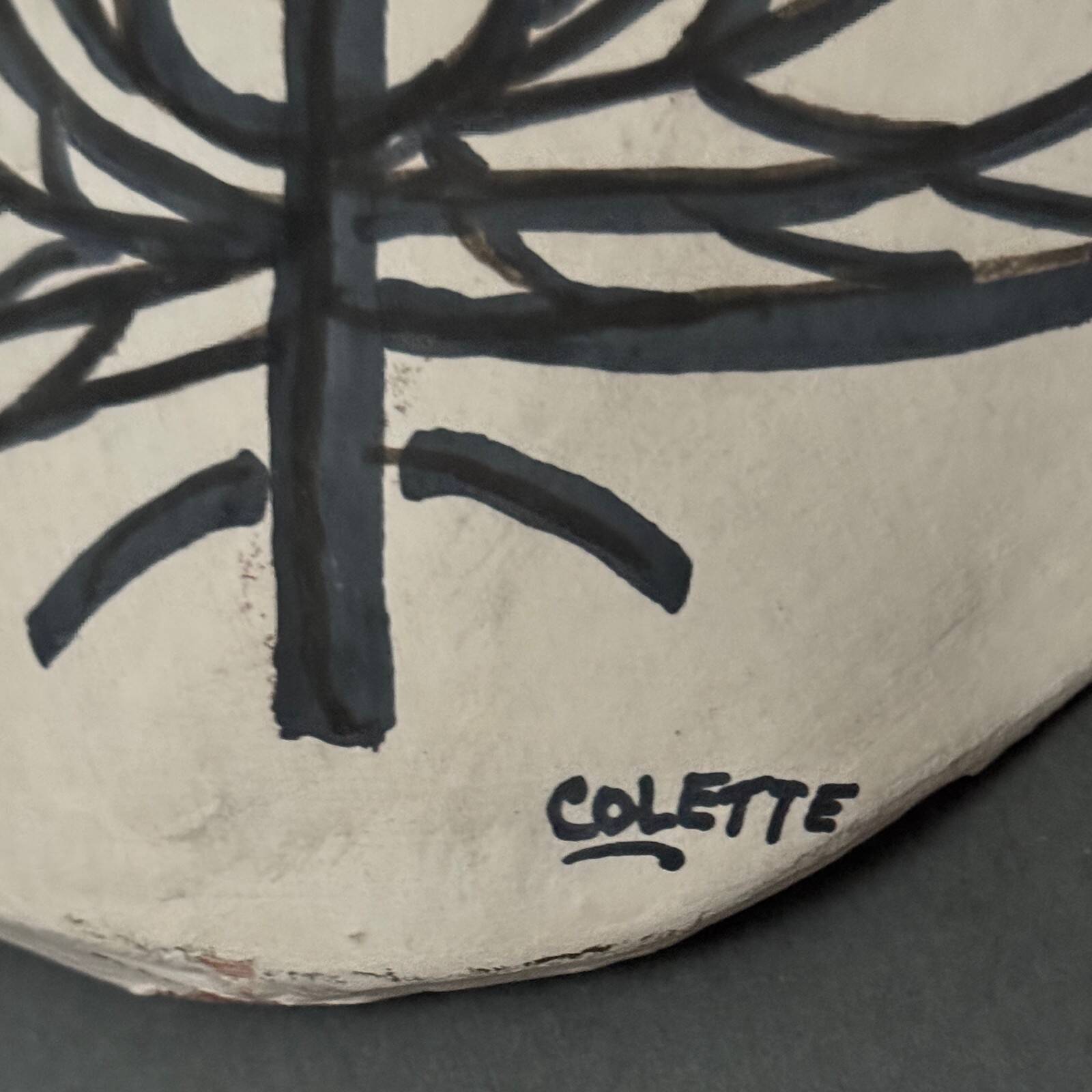 Africanist mask in glazed white terracotta, face signed Colette.