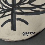Africanist mask in glazed white terracotta, face signed Colette.