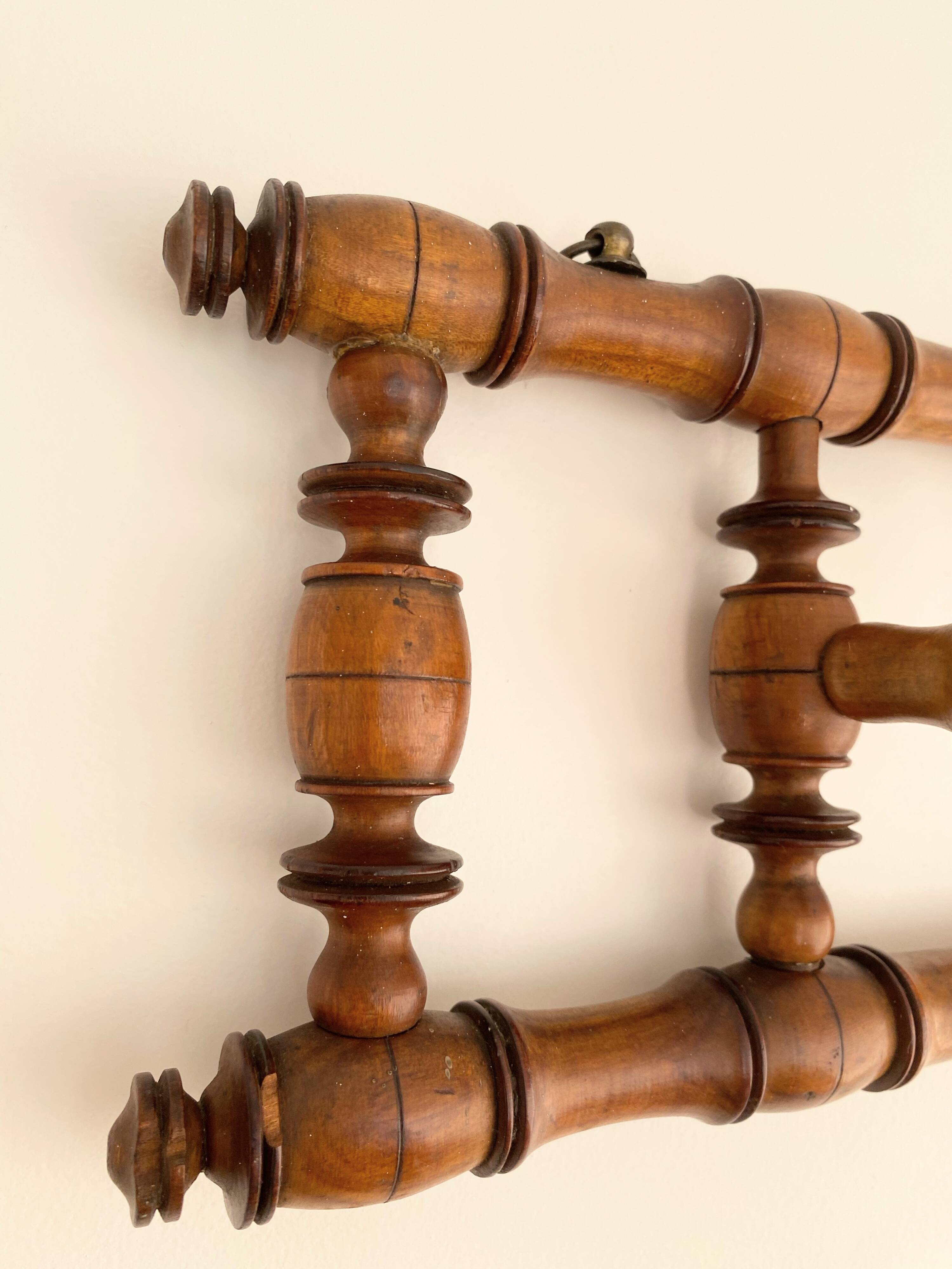 Vintage wooden wall coat rack with 4 swivel hooks from 1920