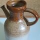 Vintage kid jug in two-tone sandstone with a handle and spout