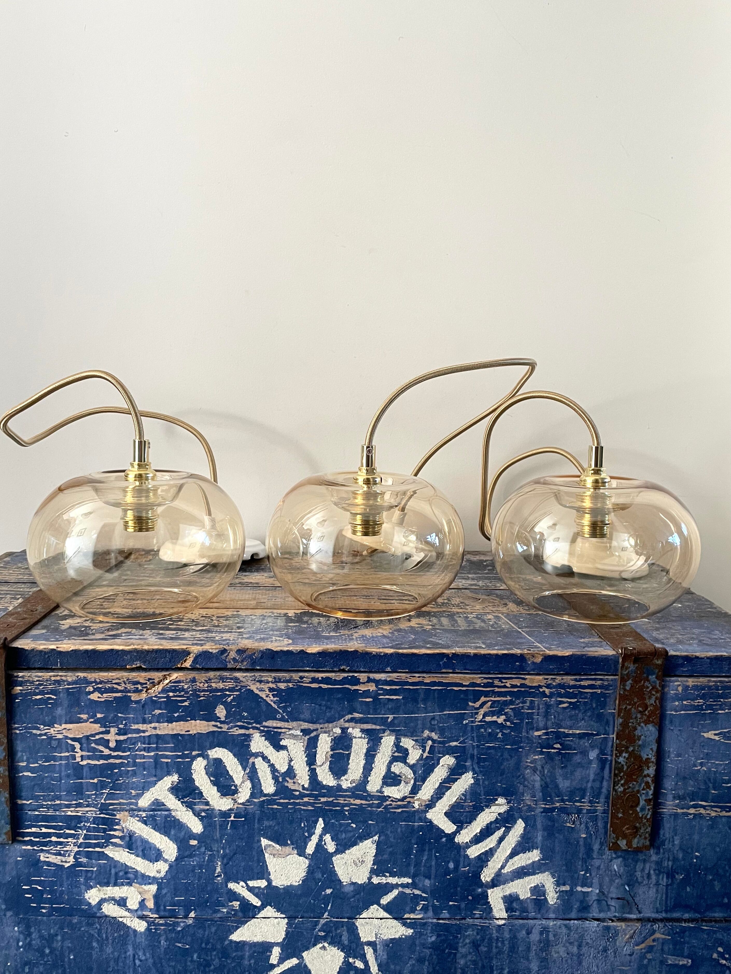 Set of three new electrified golden glass pendant lamps