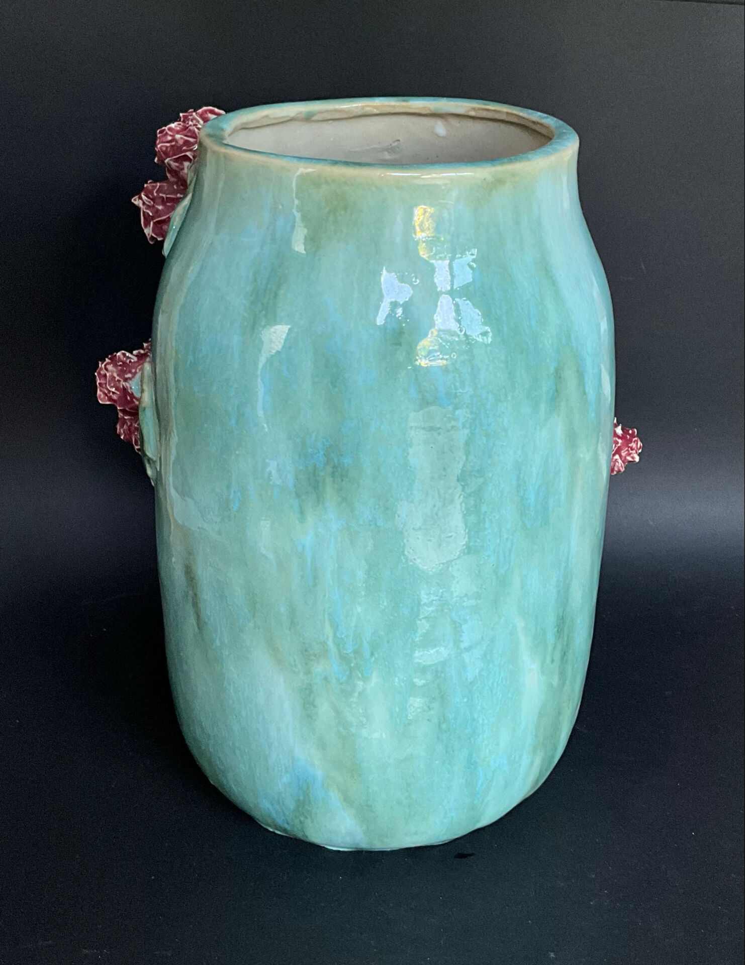 Large turquoise ceramic vase Athezza with raised floral decoration.