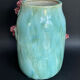 Large turquoise ceramic vase Athezza with raised floral decoration.