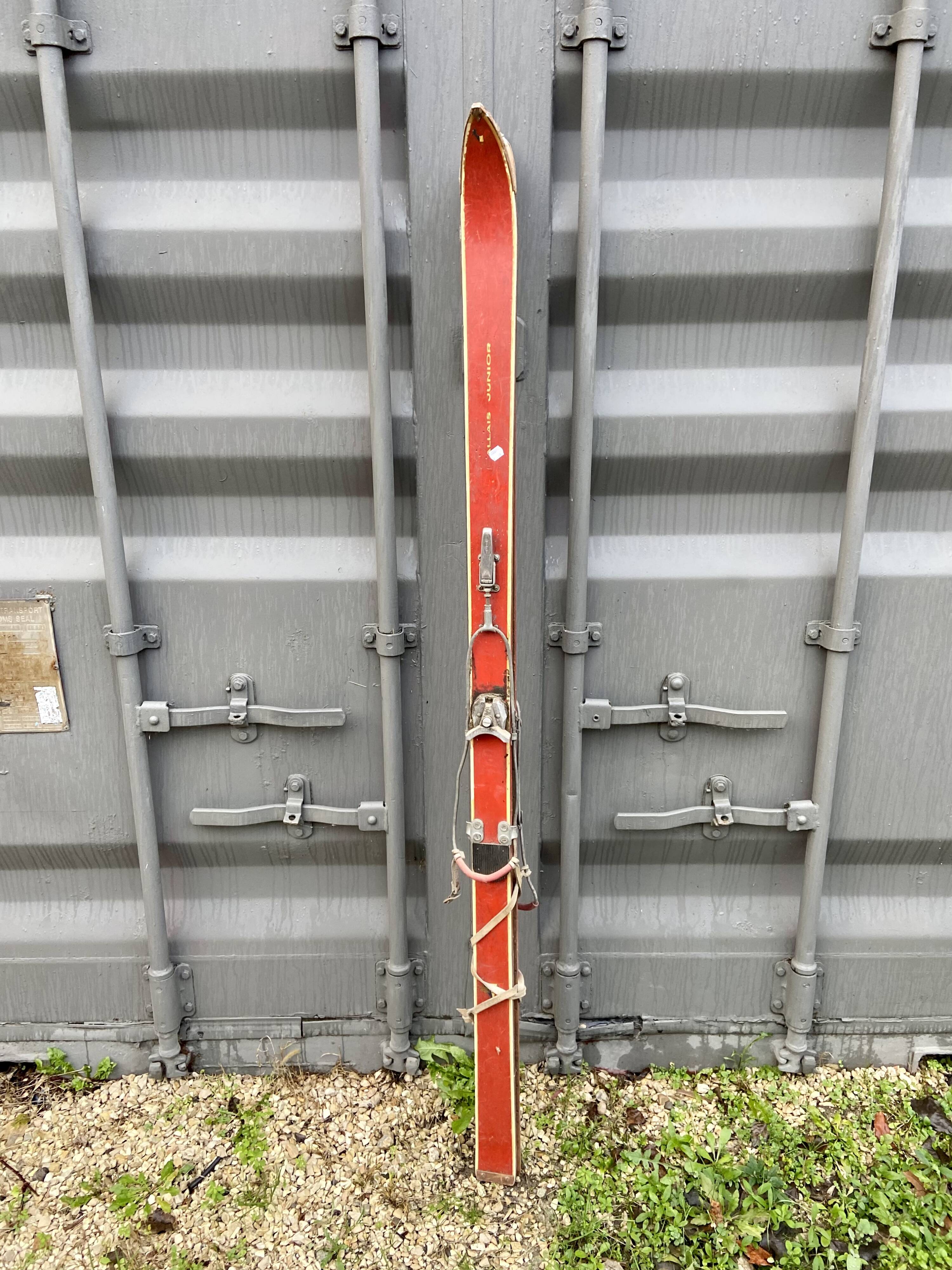 Pair of red antique skis