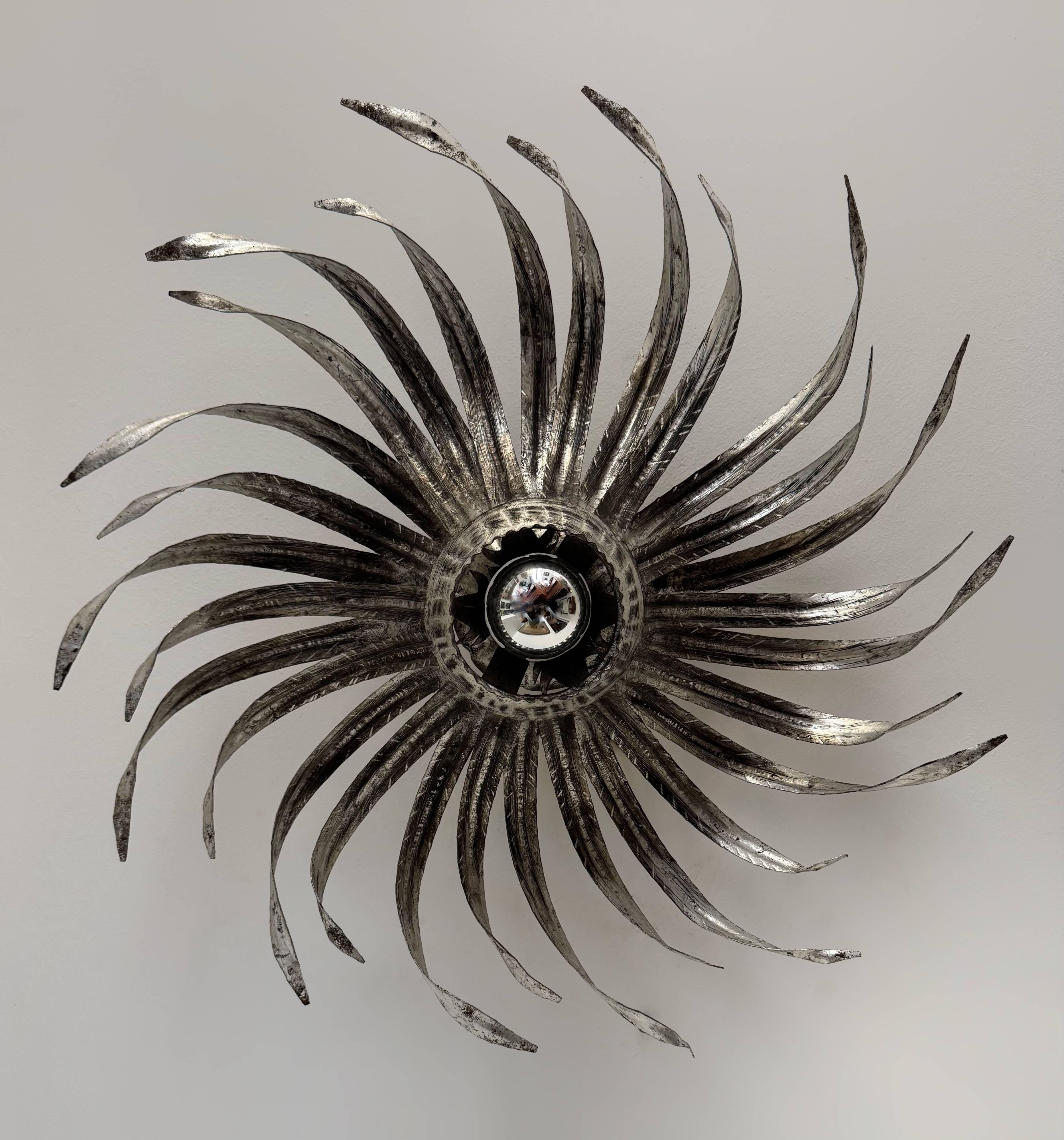 Silver wrought iron sunburst wall light from the 1960s.