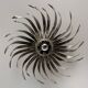 Silver wrought iron sunburst wall light from the 1960s.