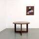 Modernist round table in solid elm, crossed legs.
