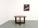 Modernist round table in solid elm, crossed legs.